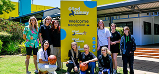 The Studio School outside of Good Sammy headquarters smiling and holding basket balls