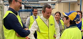 Premier Mark McGowan and Member for Jandakot Yaz Mubarakai smiling at a Good Sammy Employee with CEO Kane Blackman and team members in the background