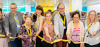 Guests and Good Sammy team cutting the yellow ribbon to celebrate the Fremantle store opening.