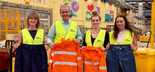 Photo of Good Sammy CEO Kane Blackman with Fibre Economy Co-Founders Shannon Itzstein, Molly Ryan and Claudi Janse Van Rensburg holding high vis clothing.