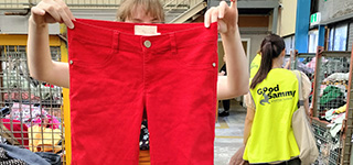 Student holding up red jeans in the Factory Outlet