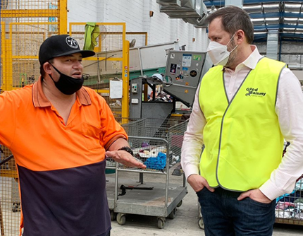 Hon Ed Husic talking to Employee Michael in the warehouse