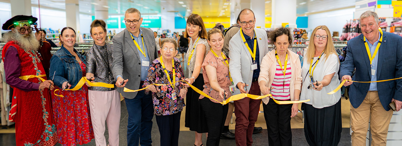 Guests and Good Sammy team cutting the yellow ribbon to celebrate the opening of the Fremantle store