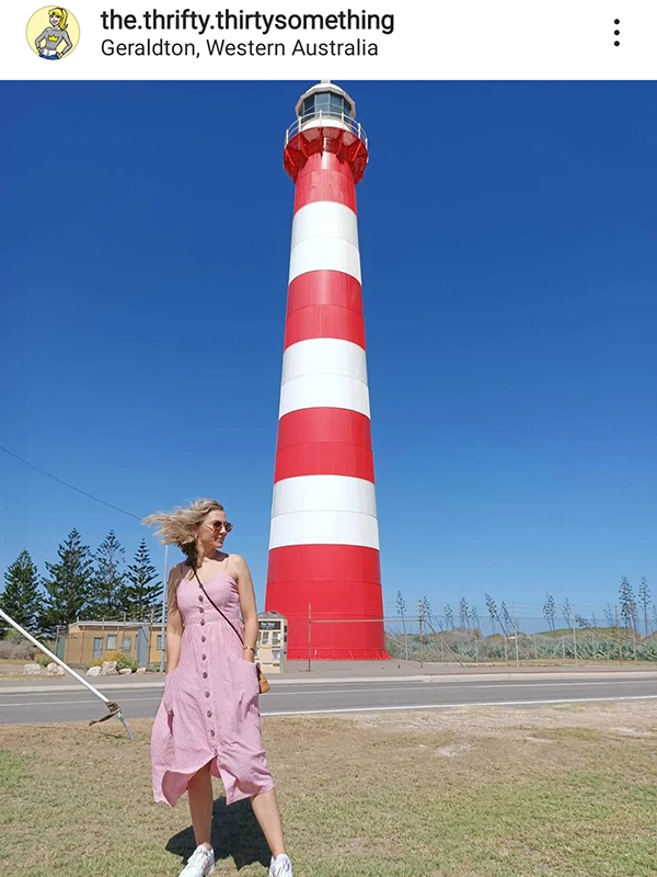 Kate Taylor wearing red and white striped Petal and Pup dress in front of Geraldton lighthouse