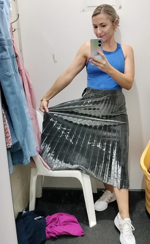 Kate Taylor wearing silver pleated skirt