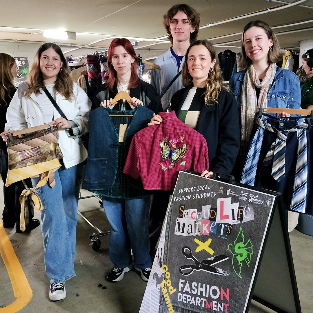 Students showing off upcycled creations