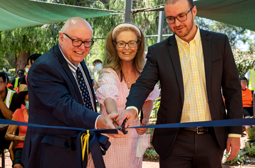 Chair Trent, CEO Melanie and future CEO Kane celebrating the opening by cutting the ribbon.