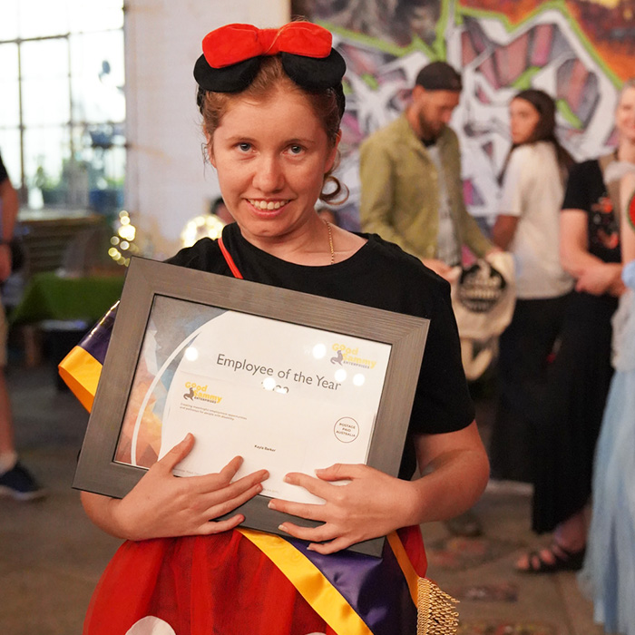 2022 Employee of the Year, Kayla Barker holding award certificate