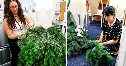 Progress shot of mannequin being dressed in a Christmas outfit. The skirt is being constructed from a Christmas tree. 