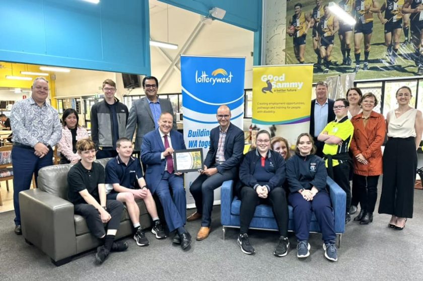 Good Sammy employees and Minister Don Punch in a group photo holding up a certificate from Lotterywest
