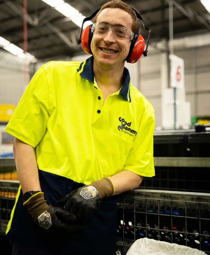 Man near conveyor belt with sound proof headwear