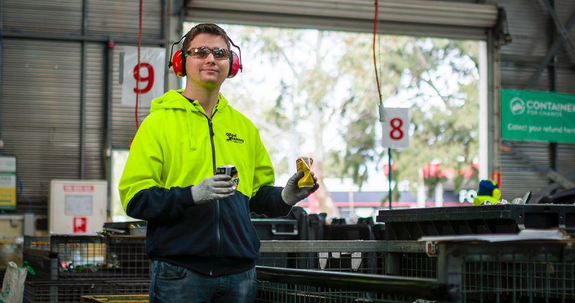 Good Sammy Containers for Change employee wearing PPE and smiling at camera.