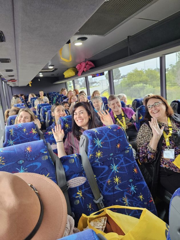 A group of people in a bus holding Good Sammy bags