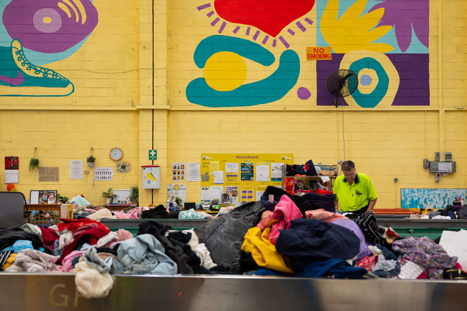 Clothes on conveyor belt at Good Sammy warehouse sorting facility